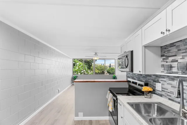 a kitchen that has a sink and a stove