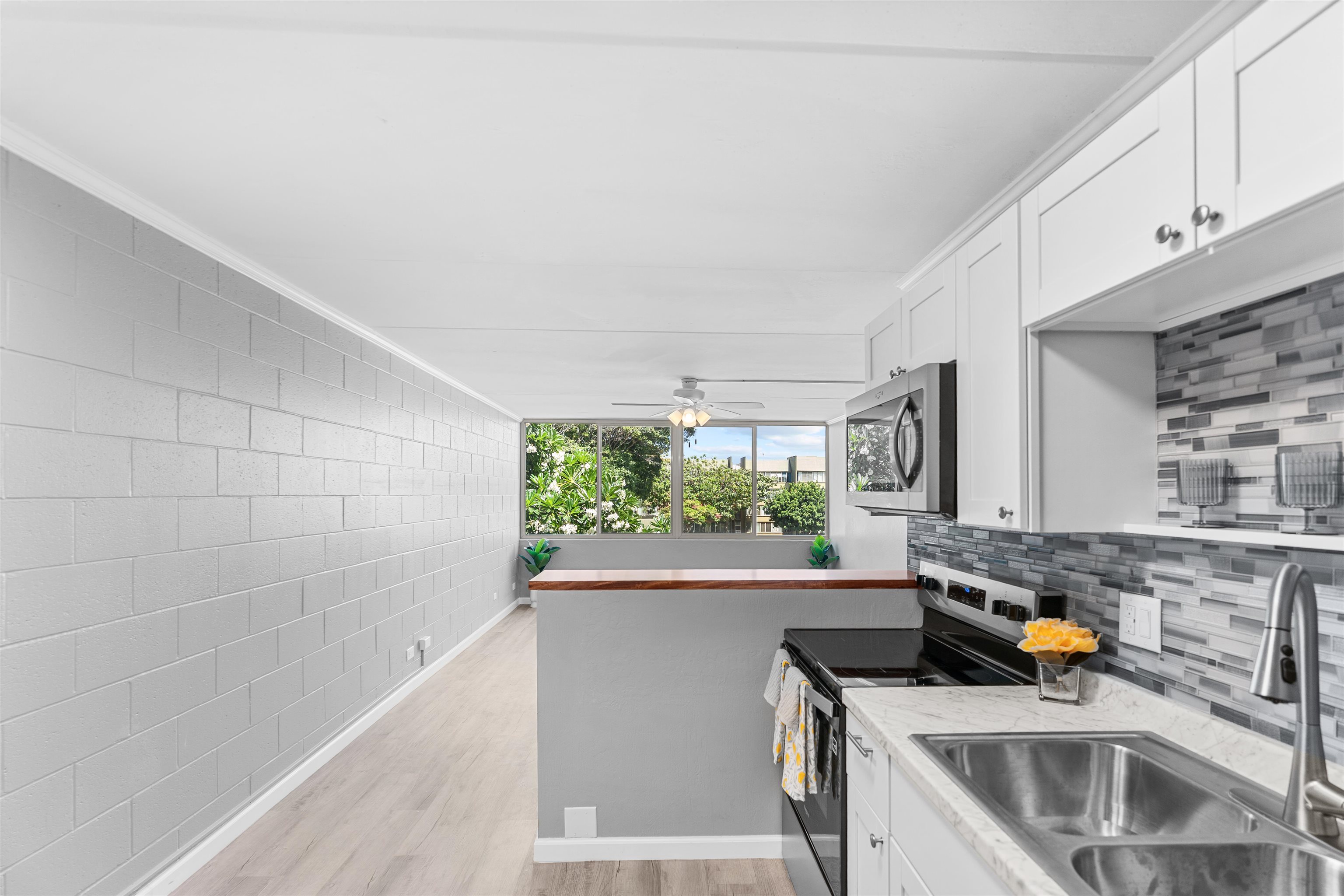 111 Kahului Beach Road, Unit D309 Kahului, HI 96732 - Photo 6 of 26 a kitchen that has a sink and a stove