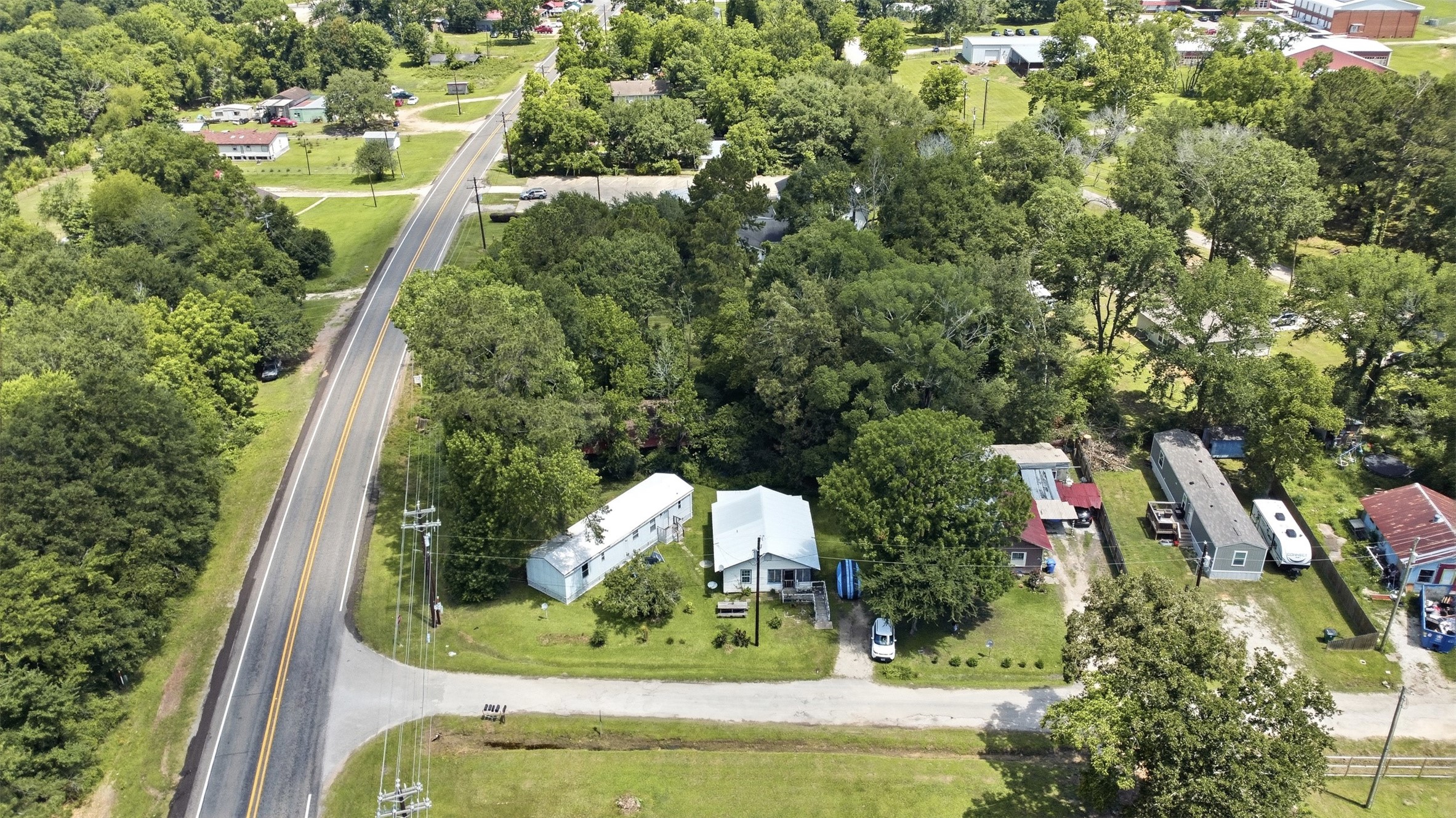 0 State Highway Loop Goodrich, TX 77335 - Photo 6 of 22 an aerial view of a house with a yard and large trees