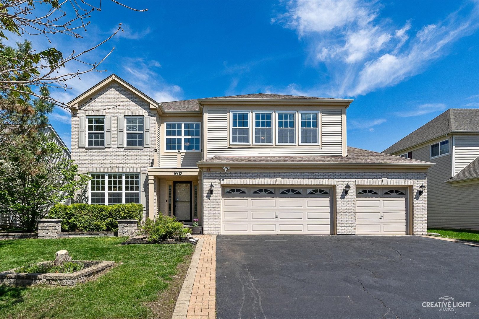 a front view of a house with a yard and garage