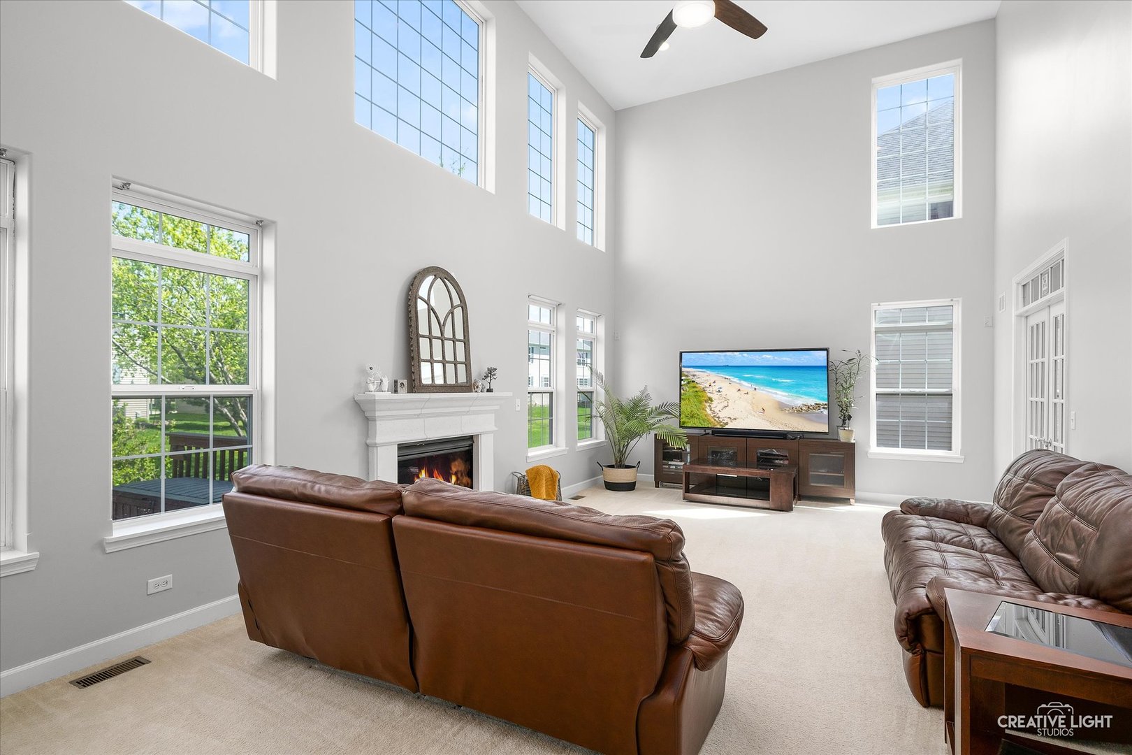 5912 Mackinac Lane Hoffman Estates, IL 60192 - Photo 12 of 32 a living room with furniture a fireplace and a flat screen tv