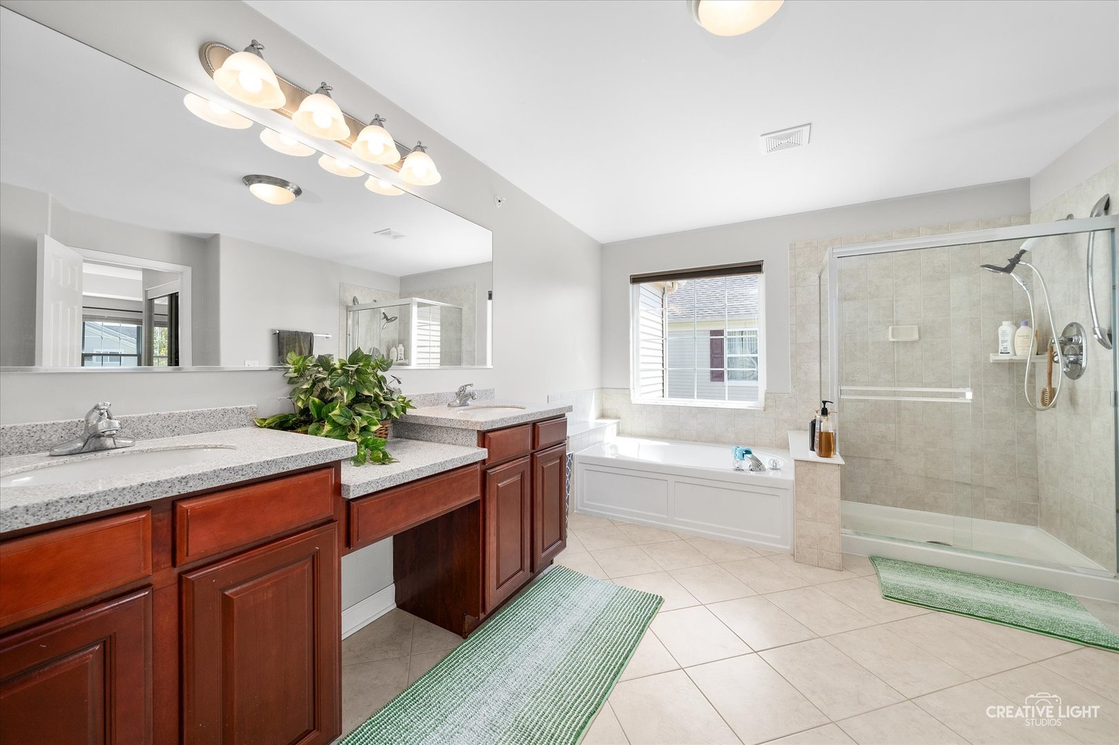 5912 Mackinac Lane Hoffman Estates, IL 60192 - Photo 21 of 32 a spacious bathroom with a granite countertop sink a toilet a mirror and bathtub
