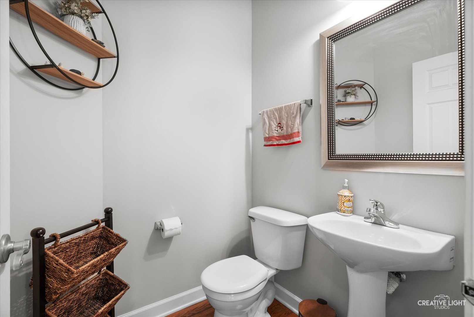 5912 Mackinac Lane Hoffman Estates, IL 60192 - Photo 6 of 32 a bathroom with a toilet a sink and mirror