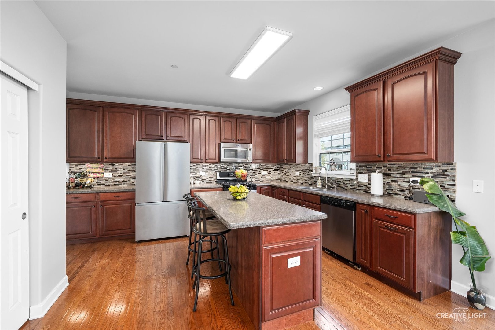 5912 Mackinac Lane Hoffman Estates, IL 60192 - Photo 8 of 32 a kitchen with refrigerator cabinets and wooden floor
