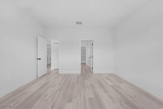 a bathroom with a double vanity sink a mirror and a shower