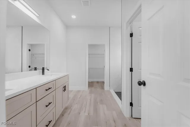 a bathroom with a double vanity sink and mirror