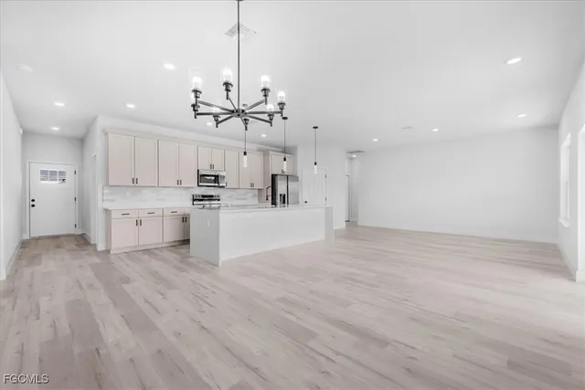 a view of a kitchen with a sink and a refrigerator