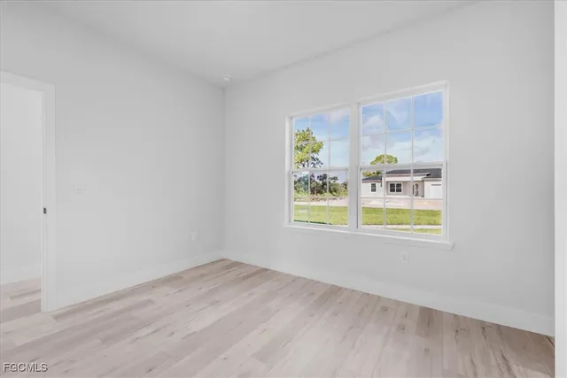 a view of a kitchen with refrigerator and white wall