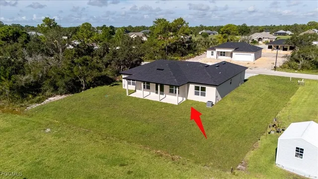 an aerial view of a house with swimming pool outdoor seating and yard
