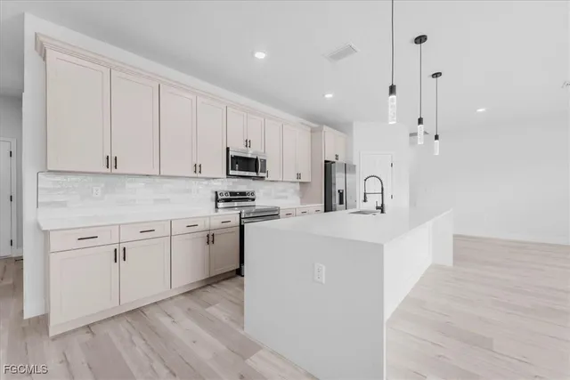 a kitchen with stainless steel appliances granite countertop a sink and cabinets