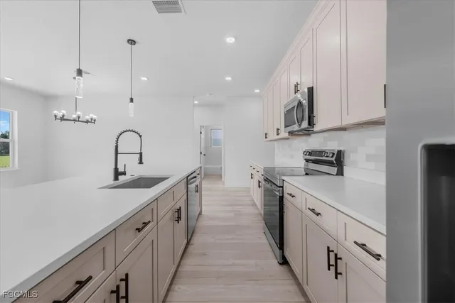 a view of a kitchen with a sink and a refrigerator