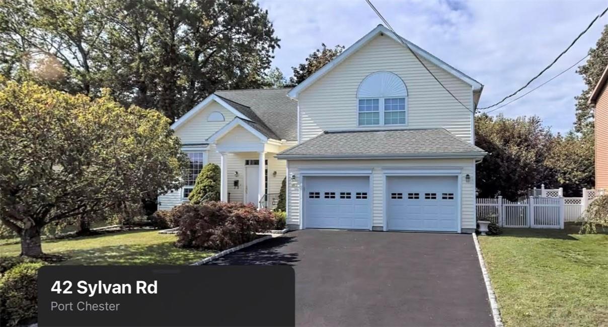 42 Sylvan Road Port Chester, NY 10573 - Photo 1 of 1 a front view of a house with a yard and garage