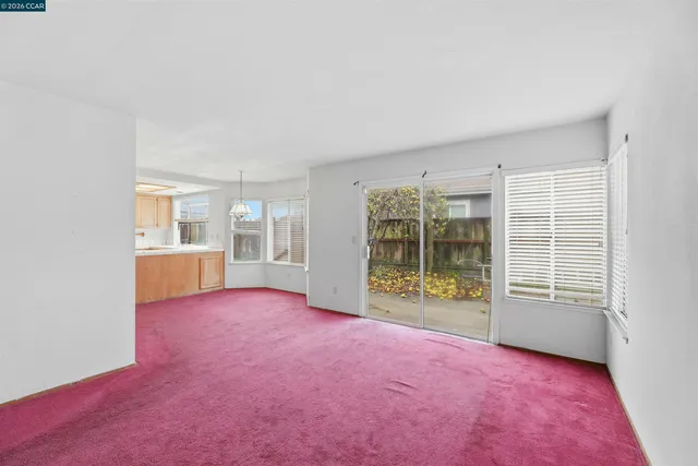 a kitchen with granite countertop white cabinets and black appliances