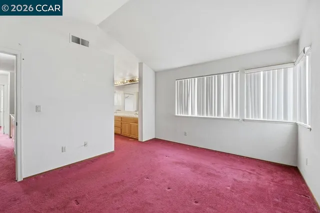 a bathroom with a granite countertop bathtub shower sink mirror and toilet