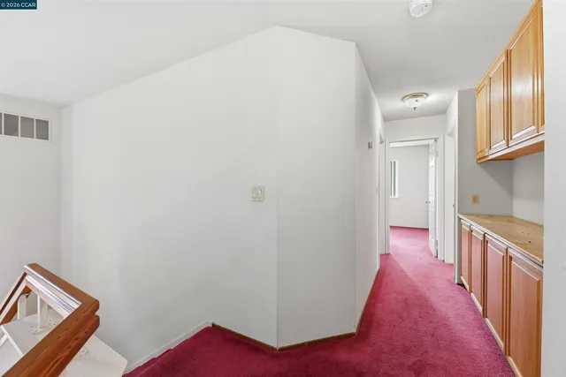 wooden floor fireplace and windows in an empty room