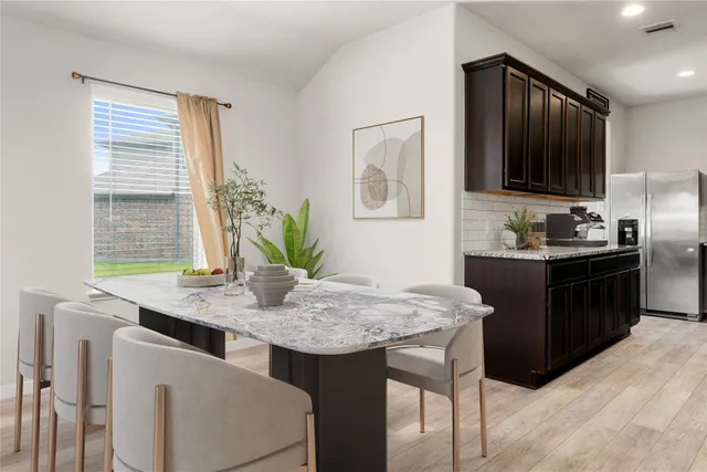 a kitchen with a table and chairs in it
