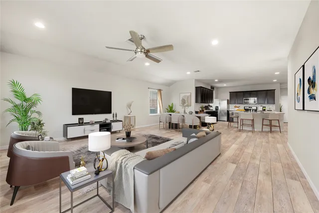 a living room with furniture a flat screen tv and a fireplace