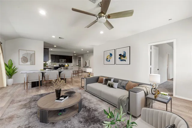 a living room with furniture and a wooden floor