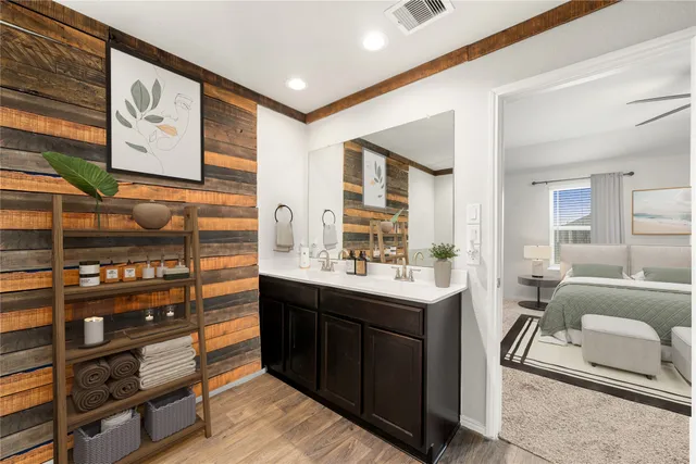 a room with stainless steel appliances kitchen island granite countertop a sink and cabinets