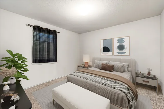 a bedroom with a bed and a potted plant