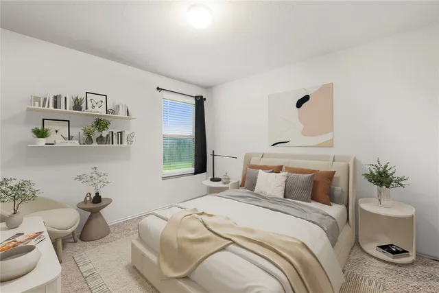 a bedroom with a bed and a potted plant