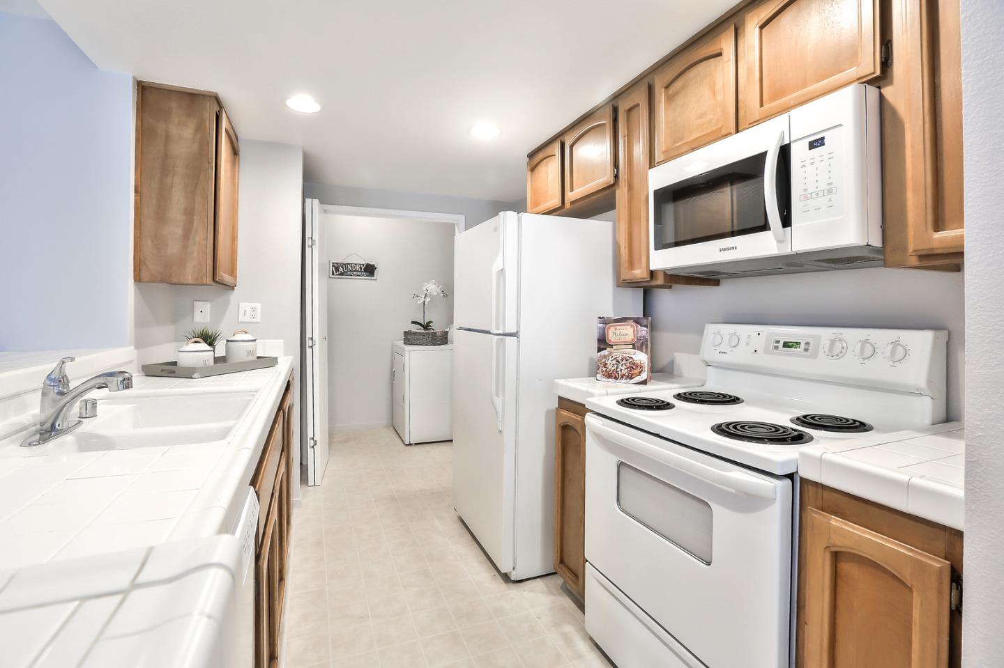 1925 Vista Cay San Mateo, CA 94404 - Photo 11 of 24 a kitchen with a stove sink and refrigerator