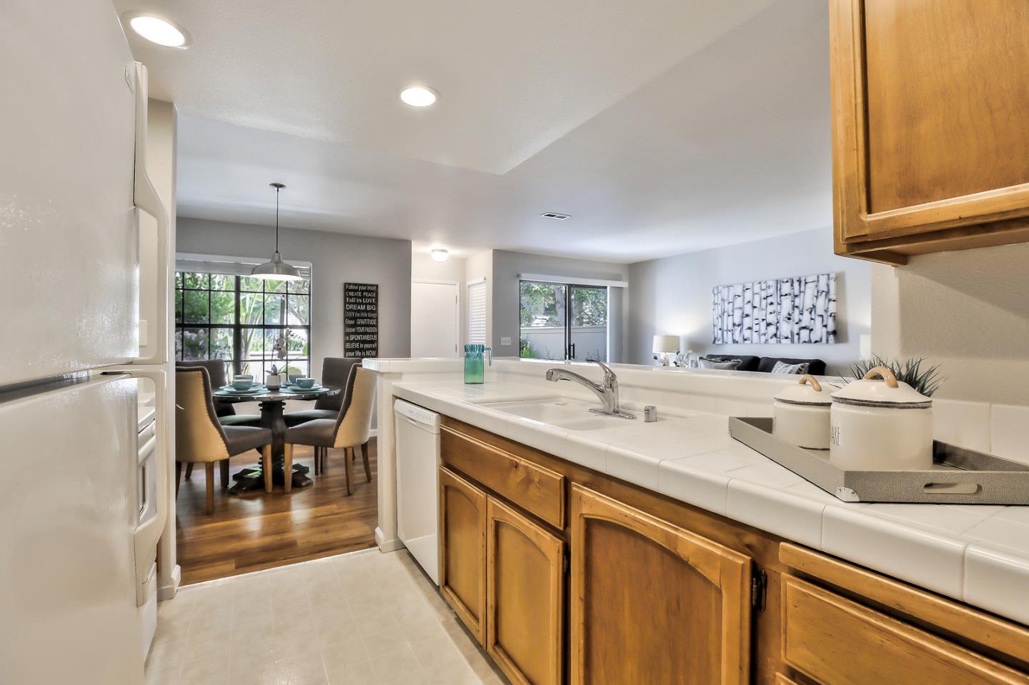 1925 Vista Cay San Mateo, CA 94404 - Photo 13 of 24 a kitchen with kitchen island granite countertop a sink cabinets and window