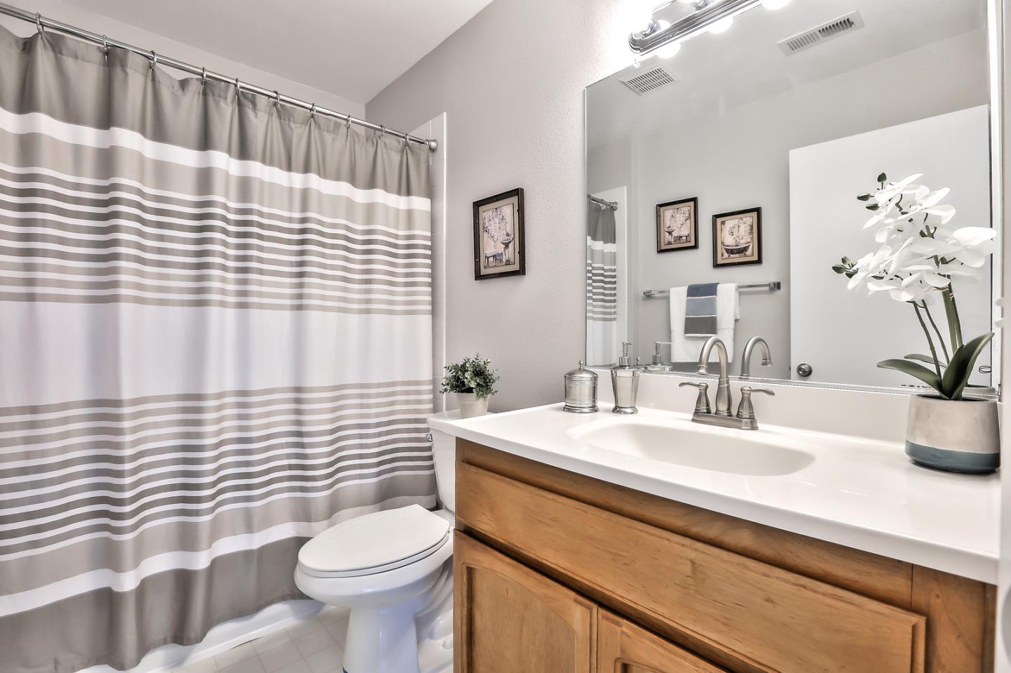 1925 Vista Cay San Mateo, CA 94404 - Photo 17 of 24 a bathroom with a sink a toilet and mirror