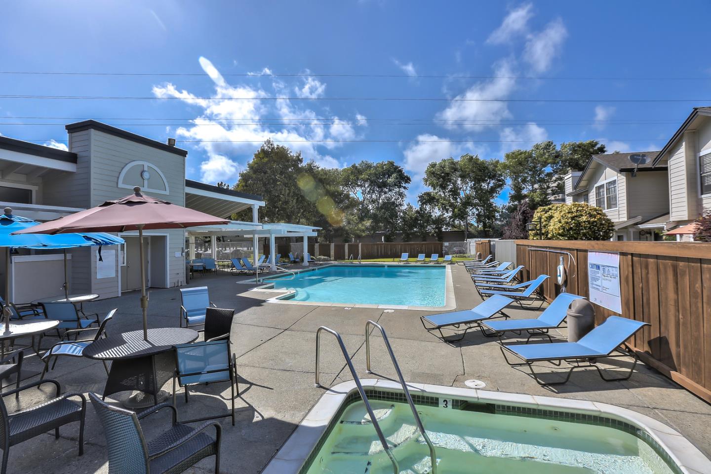 1925 Vista Cay San Mateo, CA 94404 - Photo 20 of 24 a roof deck with table and chairs under an umbrella with a fire pit