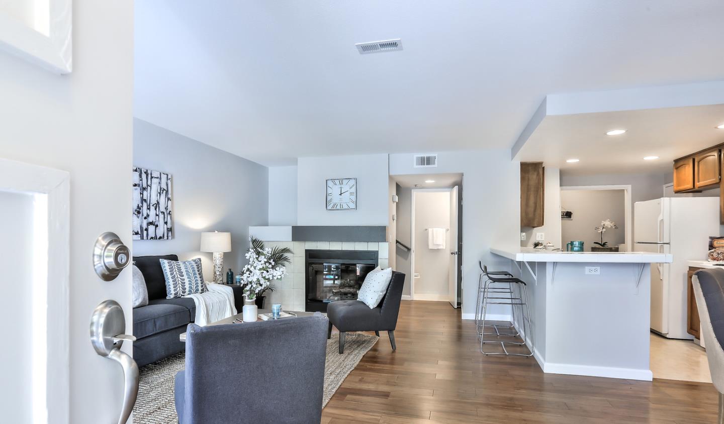 1925 Vista Cay San Mateo, CA 94404 - Photo 6 of 24 a living room with furniture a fireplace and a table