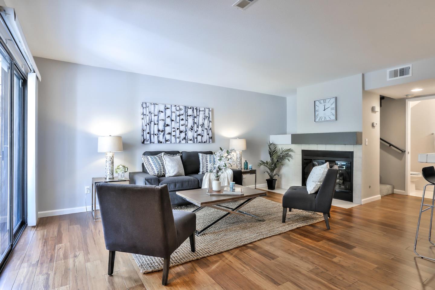 1925 Vista Cay San Mateo, CA 94404 - Photo 7 of 24 a living room with furniture a fireplace and a lamp