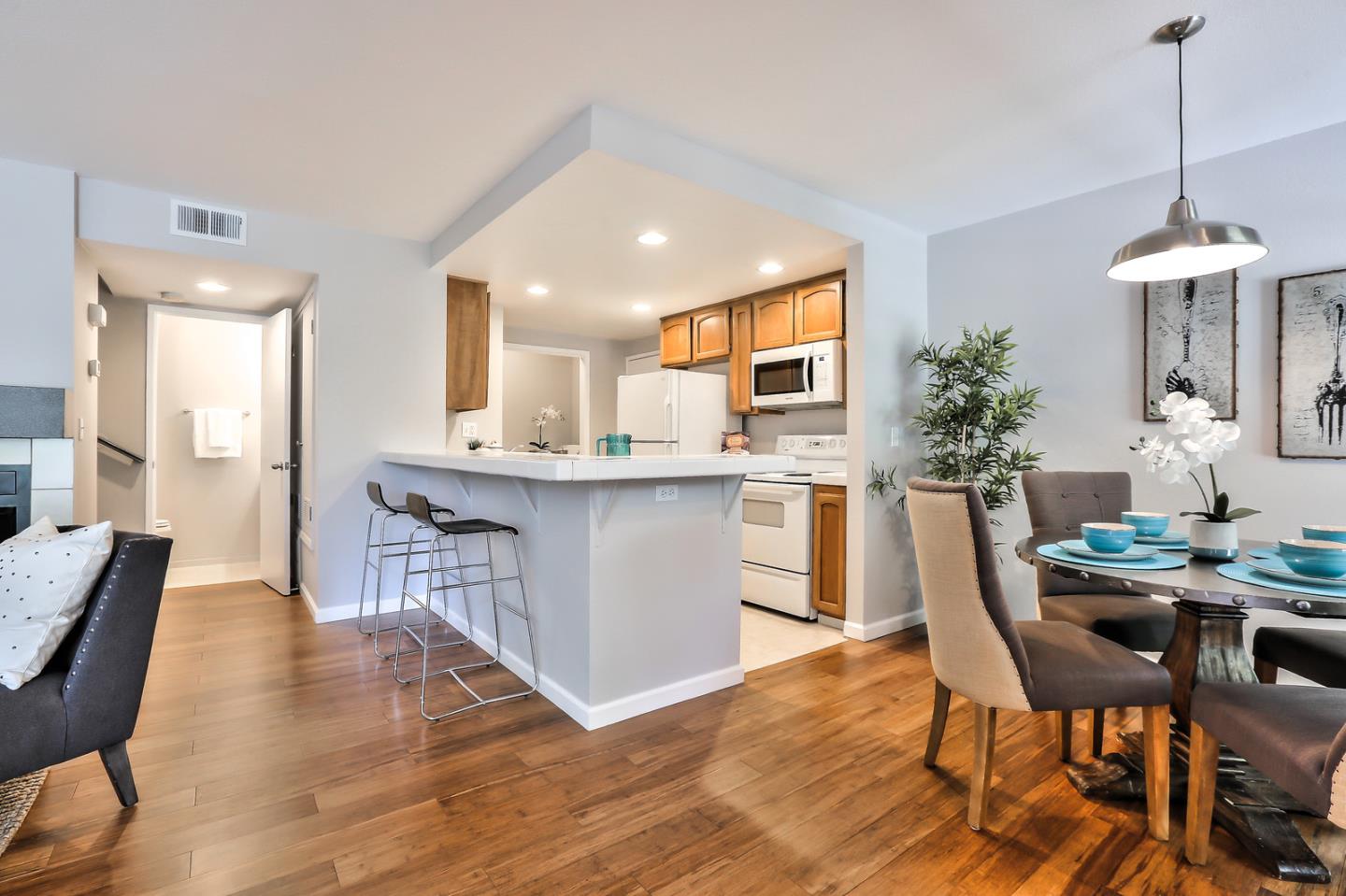 1925 Vista Cay San Mateo, CA 94404 - Photo 9 of 24 a dining room filled chandelier and wooden floor