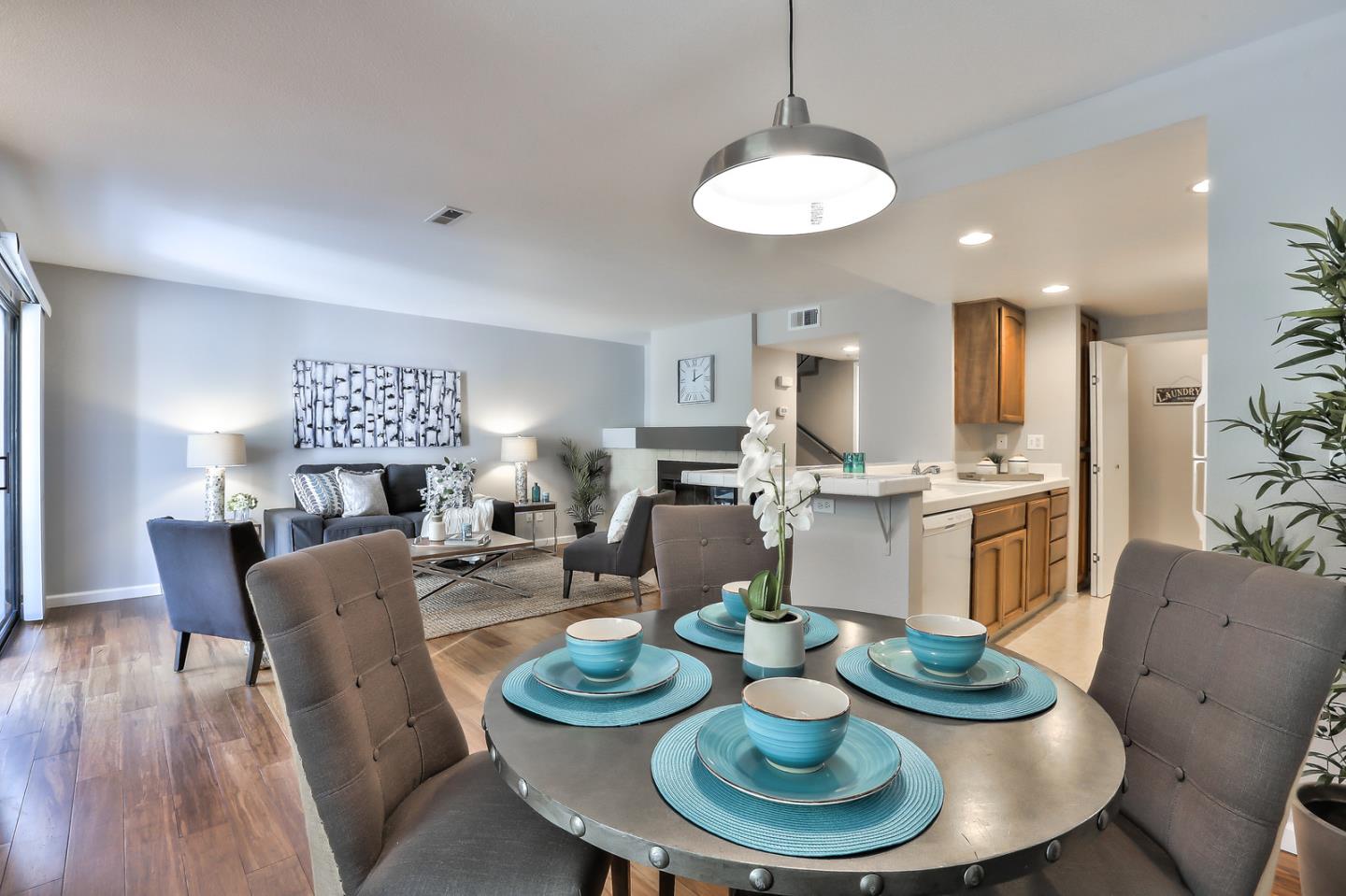1925 Vista Cay San Mateo, CA 94404 - Photo 10 of 24 a living room with furniture kitchen and a chandelier