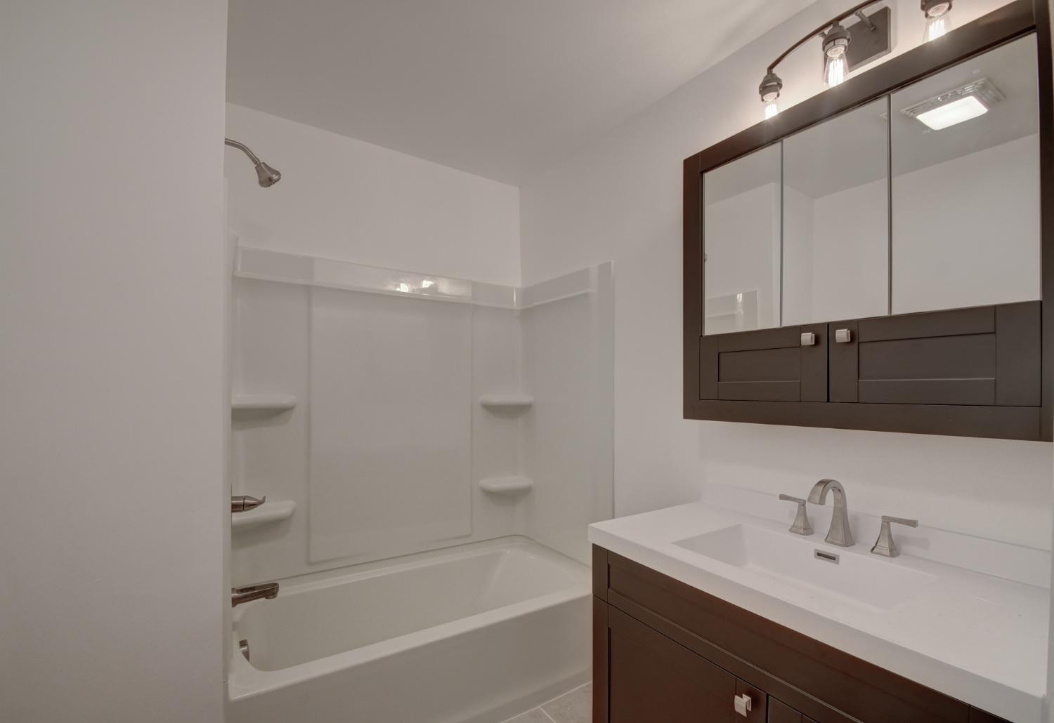 1604 Webber Street La Porte, IN 46350 - Photo 20 of 22 a bathroom with a tub sink a mirror and shower