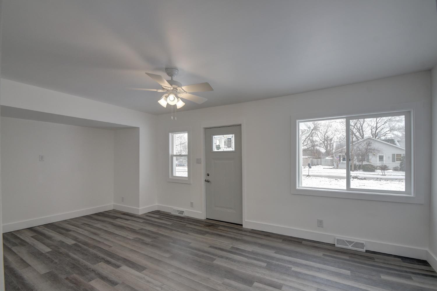 1604 Webber Street La Porte, IN 46350 - Photo 9 of 22 a view of an empty room with wooden floor and a window