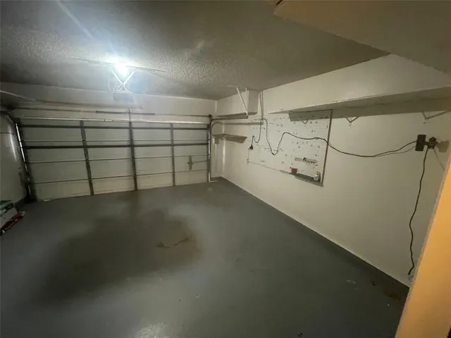 a view of a garage with racks on the wall