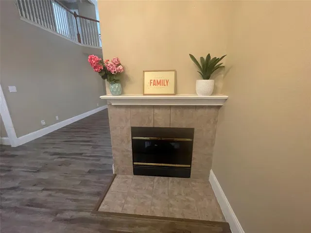 a living room with a fireplace and a potted plant