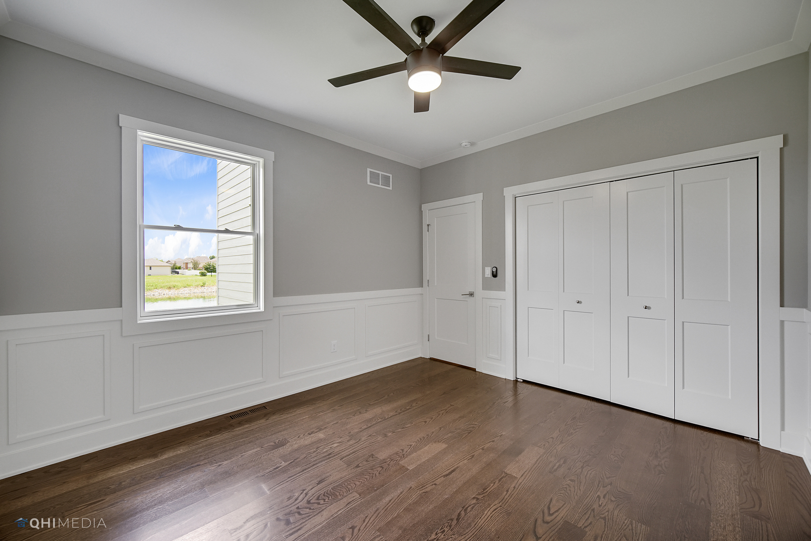 8233 Castle Drive Munster, IN 46321 - Photo 6 of 19 a view of an empty room with a window and wooden floor