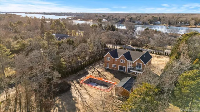 an aerial view of a house with a yard and wooden fence