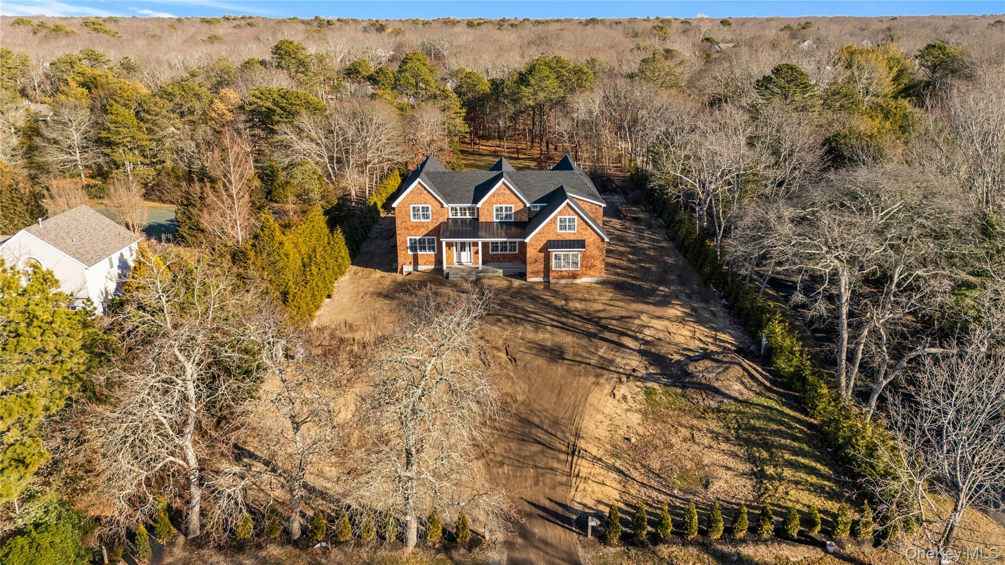34 Old Main Road Quogue, NY 11959 - Photo 9 of 16 an aerial view of a house with a yard and wooden fence