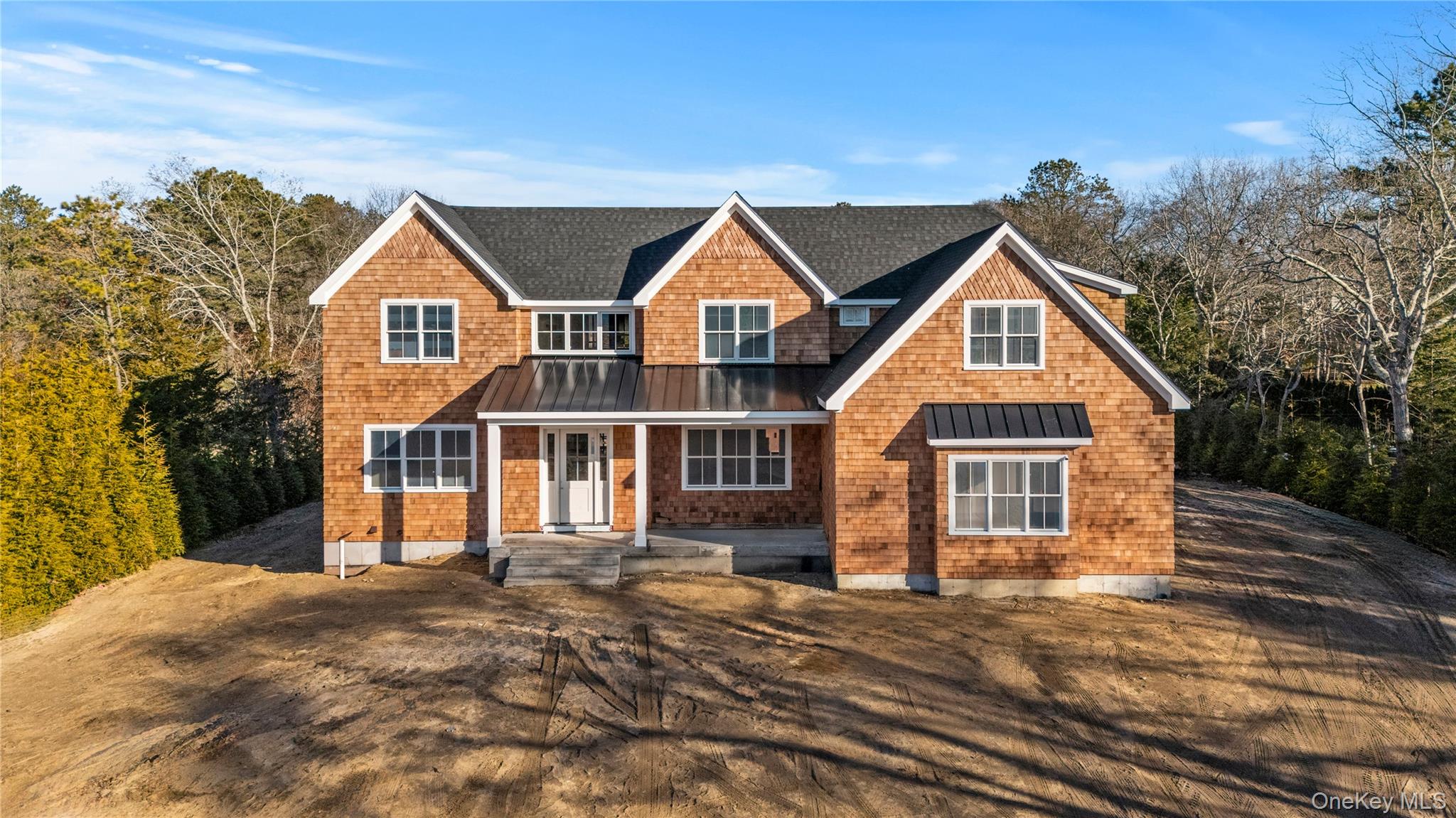 34 Old Main Road Quogue, NY 11959 - Photo 10 of 16 a front view of a house with a yard