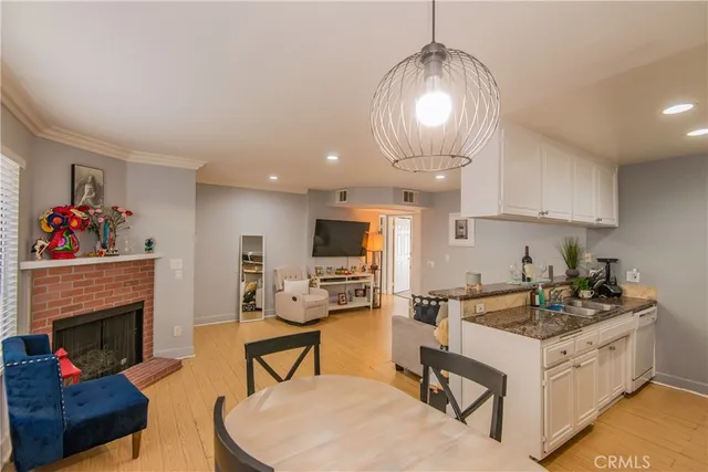 a kitchen with a stove cabinets and living room view