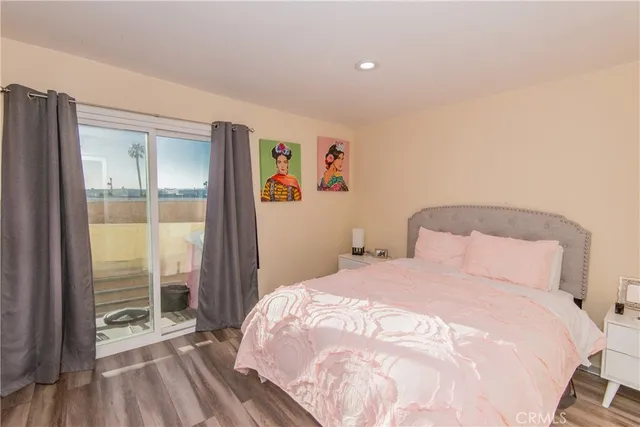 a bedroom with a bed and a large window