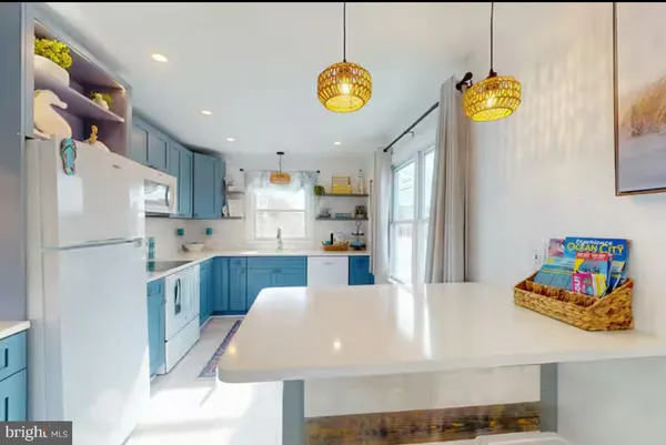 a kitchen with refrigerator and window