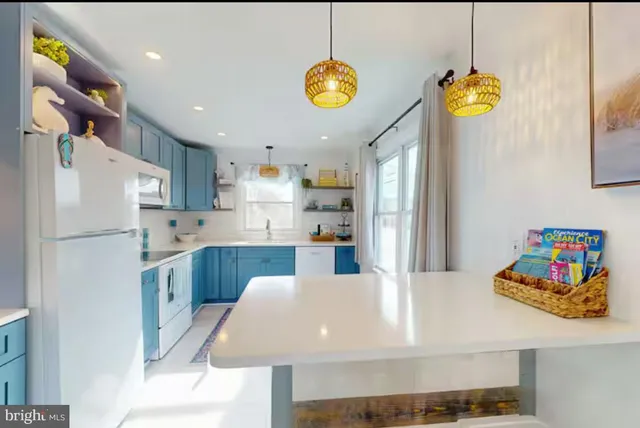 a kitchen with refrigerator and window