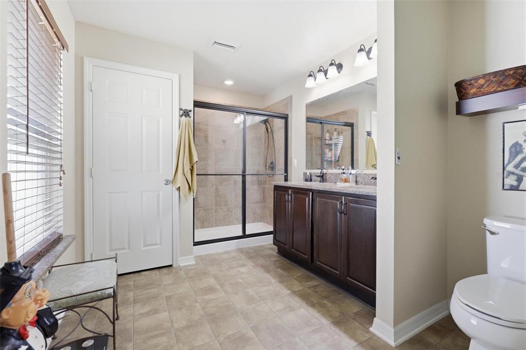 656 Carya Court DeLand, FL 32724 - Photo 14 of 28 a bathroom with a sink mirror toilet and shower