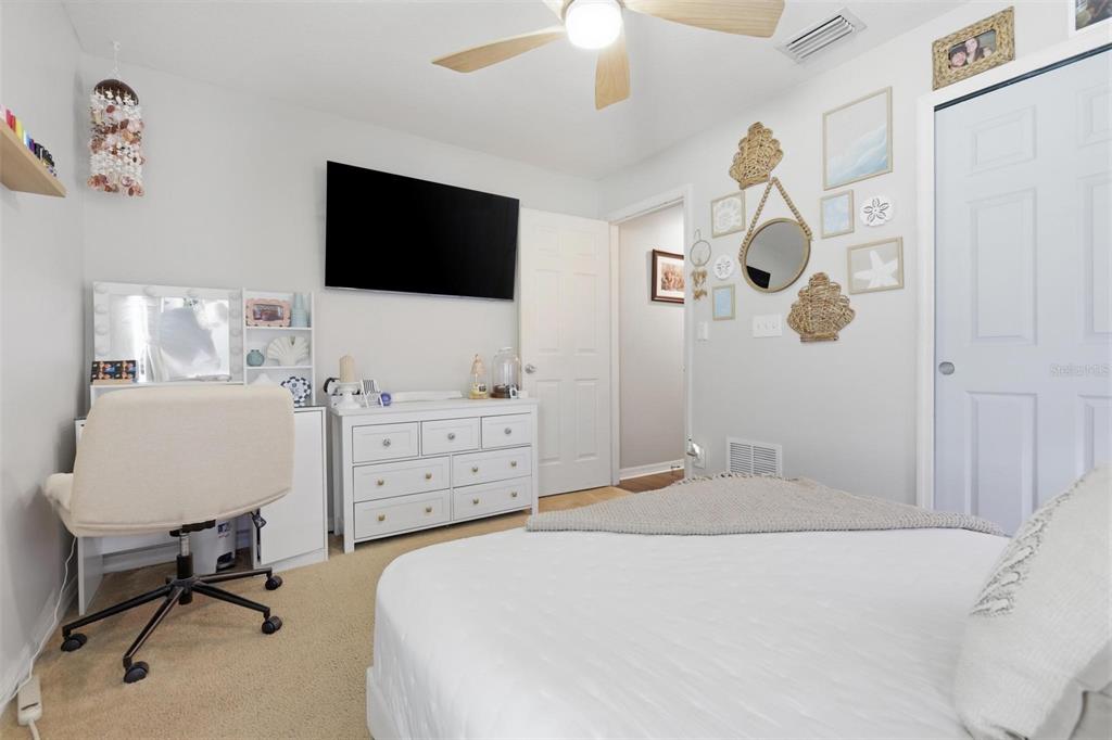 656 Carya Court DeLand, FL 32724 - Photo 20 of 28 a bedroom with a bed and a flat screen tv