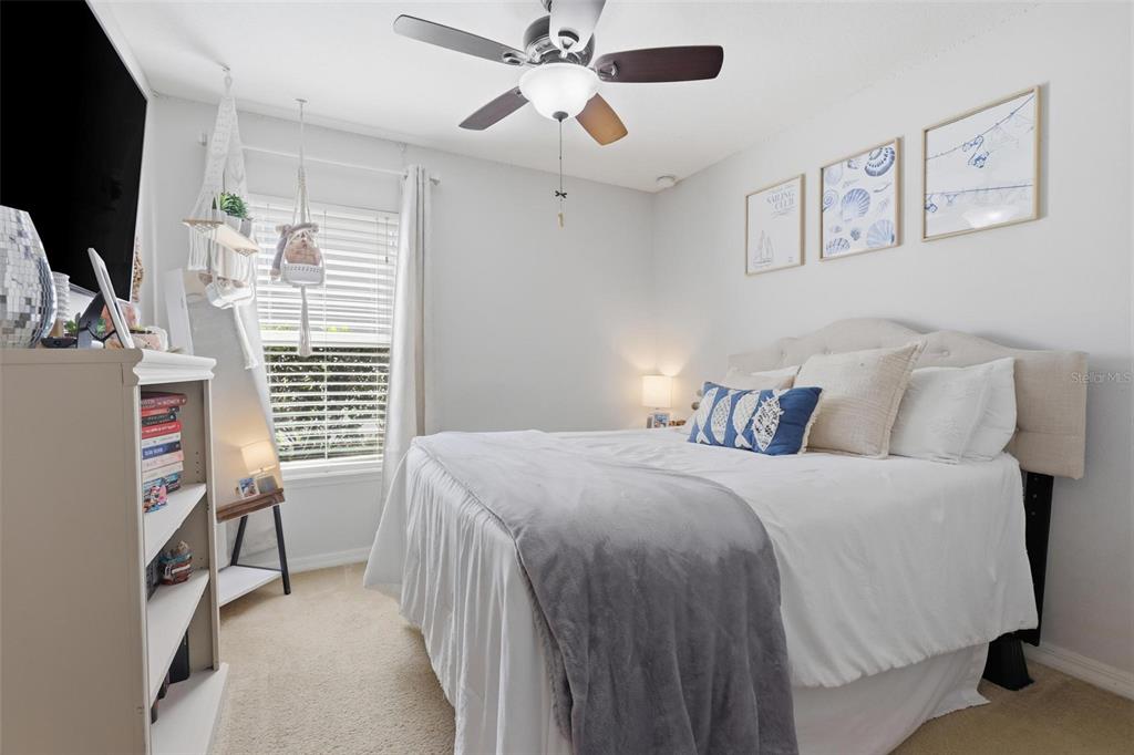 656 Carya Court DeLand, FL 32724 - Photo 21 of 28 a bedroom with a bed and a chandelier