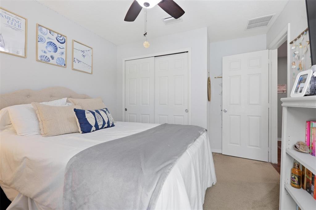 656 Carya Court DeLand, FL 32724 - Photo 22 of 28 a bedroom with a bed and a chandelier