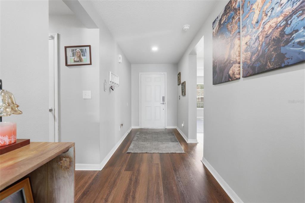 656 Carya Court DeLand, FL 32724 - Photo 4 of 28 a view of a hallway with wooden floor